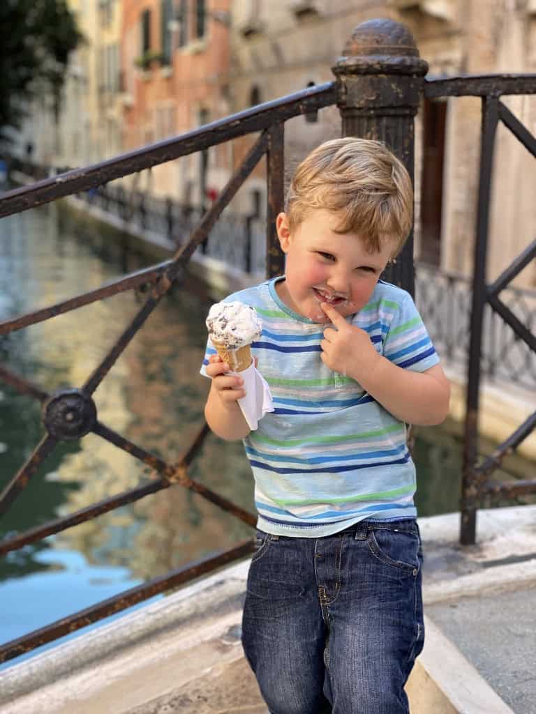 Benjamin enjoying his ice cream by one of the Venice canals