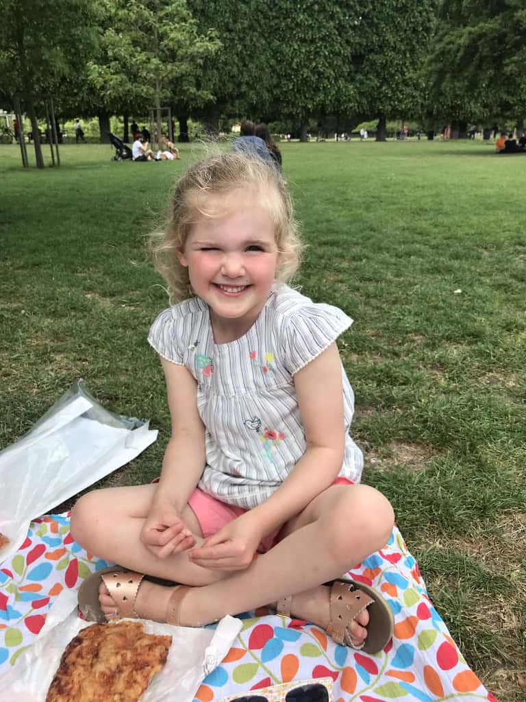 Chloe eating her picnic lunch in the King's gardens, next to Rosenborg castle, Copenhagen.
