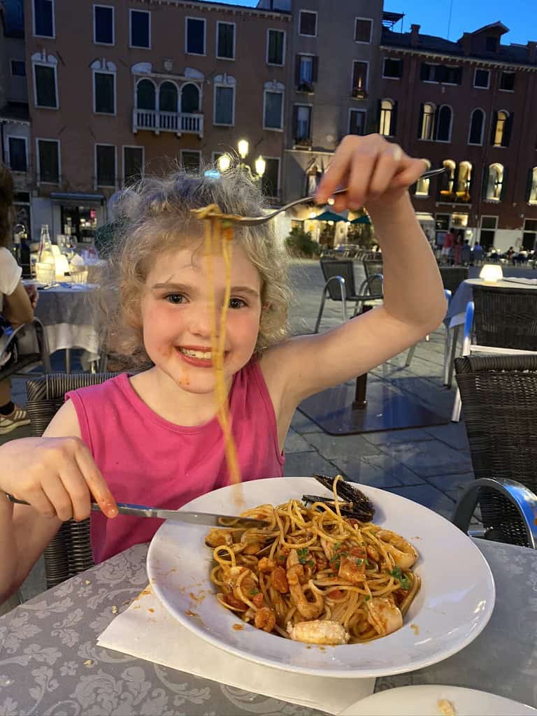 Chloe enjoying seafood spaghetti in the Campo Stefano square in venice