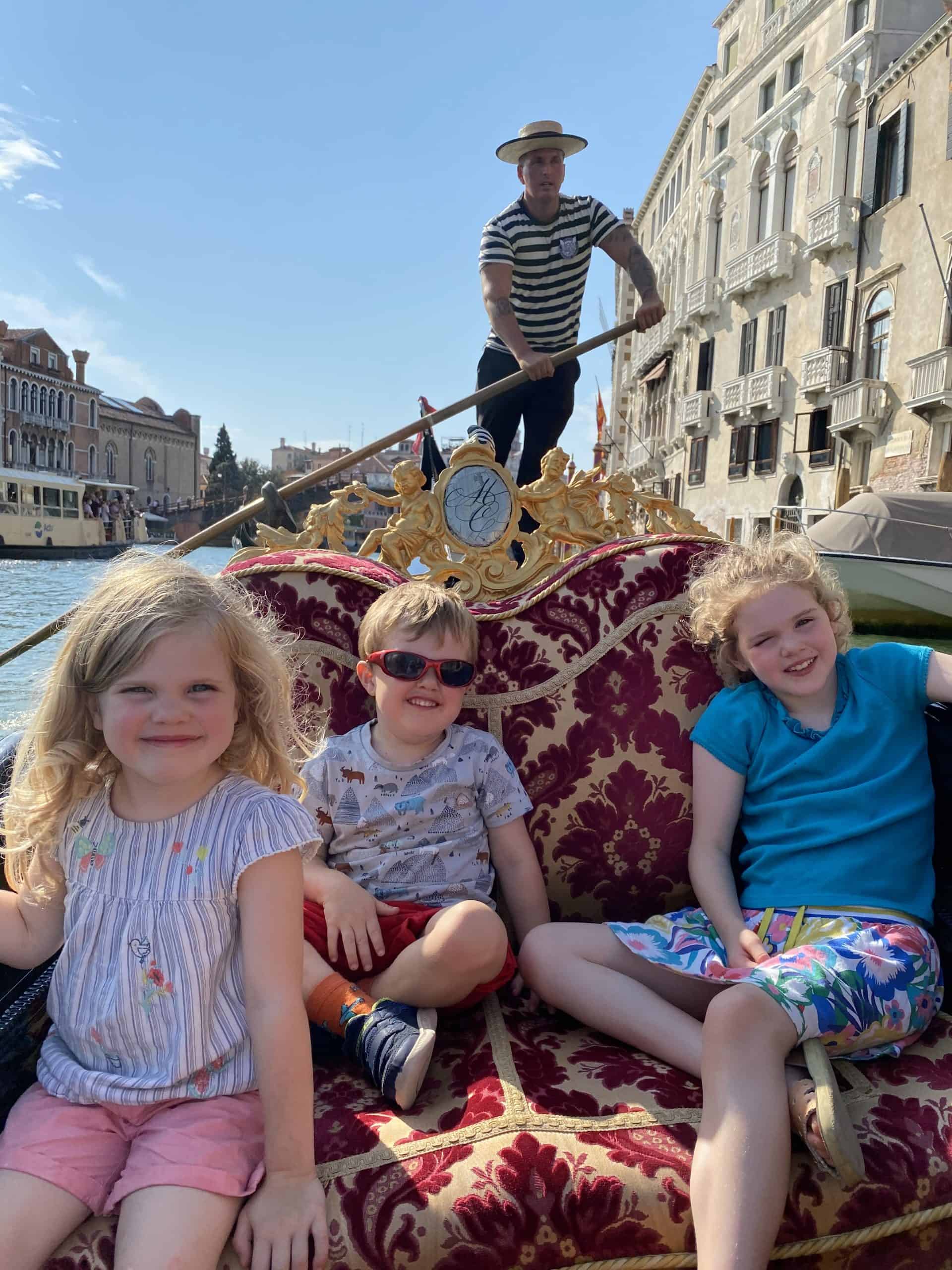 Children enjoying gondola ride in Venice.