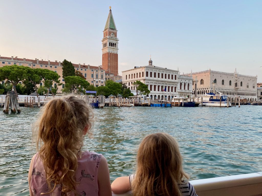Two girls looking out over the Venetian lagoon in Venice.