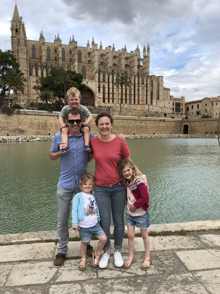 Family standing in front of cathedral in Palma de Mallorca