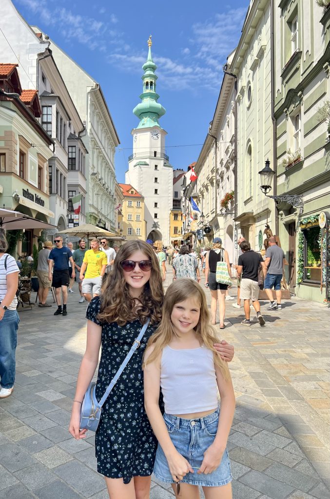Chloe and Martha standing in the old town of Bratislava in front of St Stephens gate.