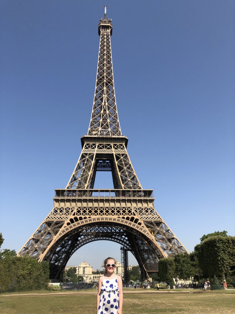 Child standing in front of the Eiffel Tower, Paris