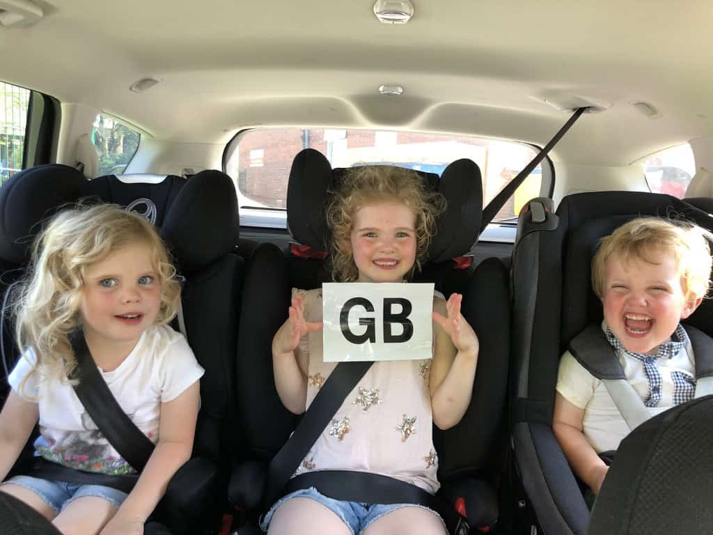Excited children in the back of the car driving from the UK to the Vendee.