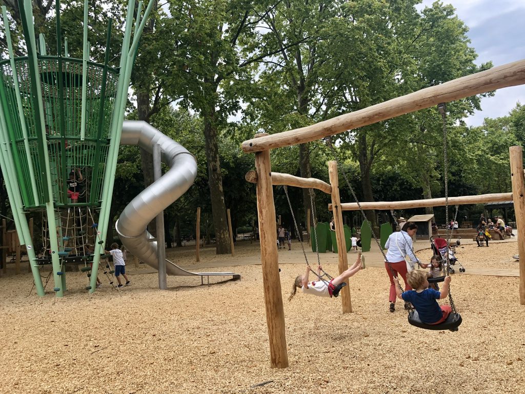 Children playing inside the playground within the Luxemboug gardens.