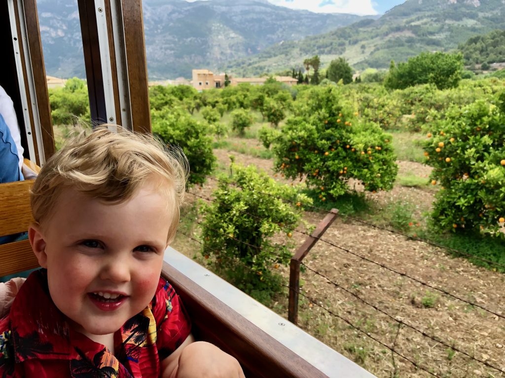 Benjamin enjoying the vintage tram ride through the orange groves from Soller to Port de Soller. 