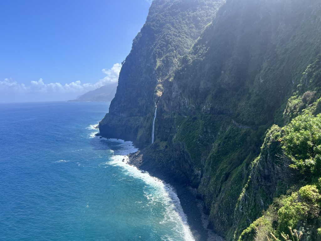 The Véu da Noiva waterfall crashing from the cliffs into the ocean in northern Madeira. 