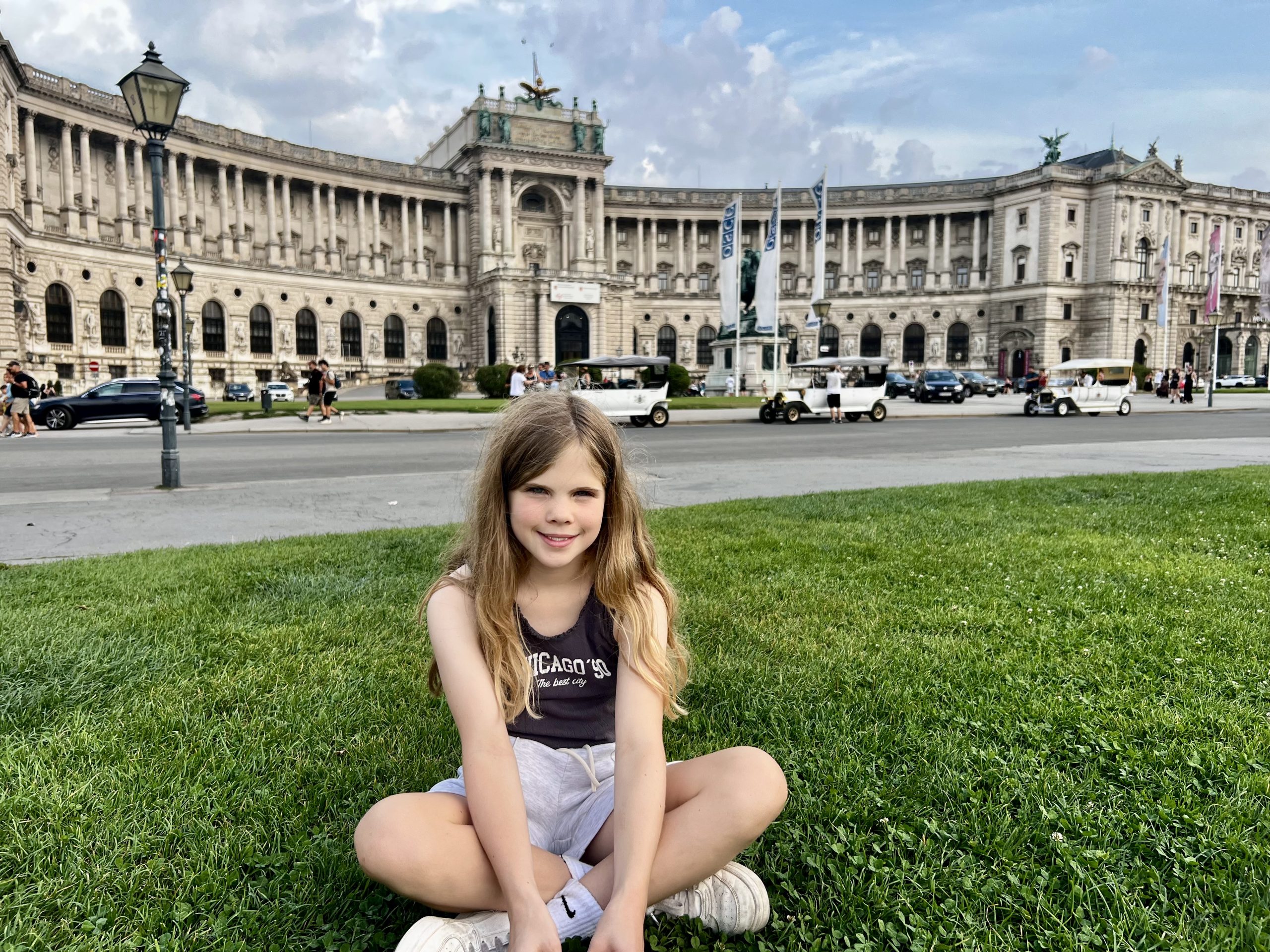Taking  a rest on the grass outside Hofburg palace