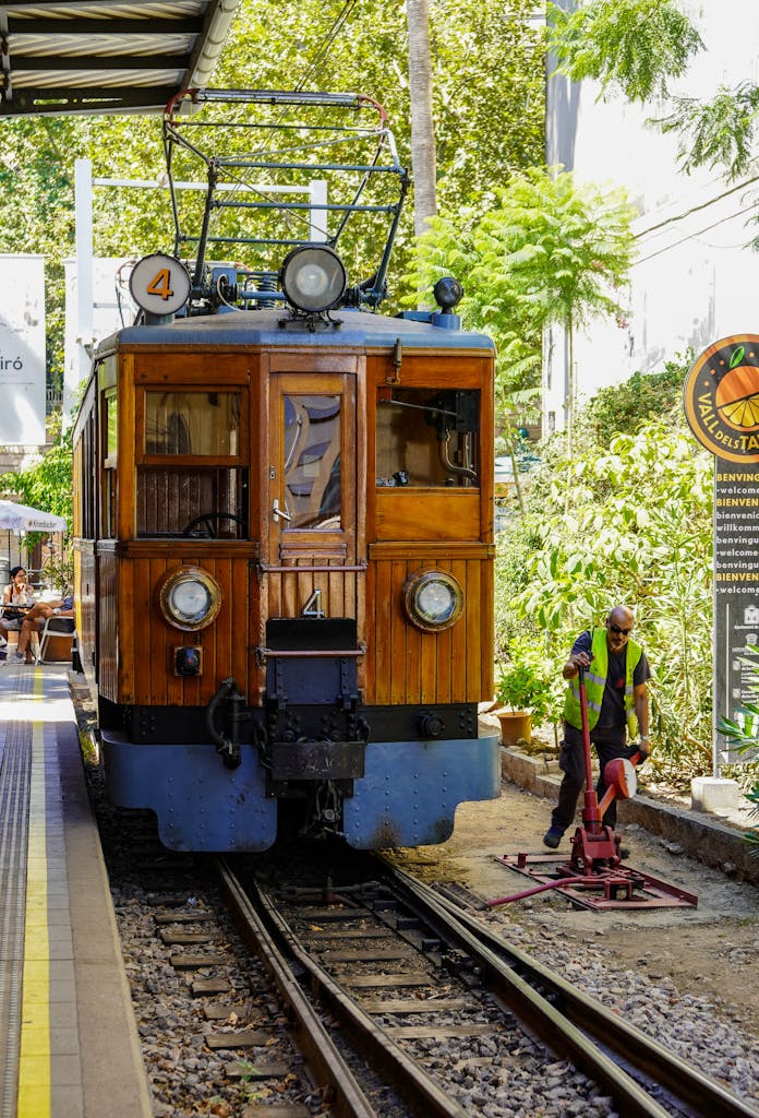 A charming vintage tram at the scenic Palma station in Mallorca, Spain.