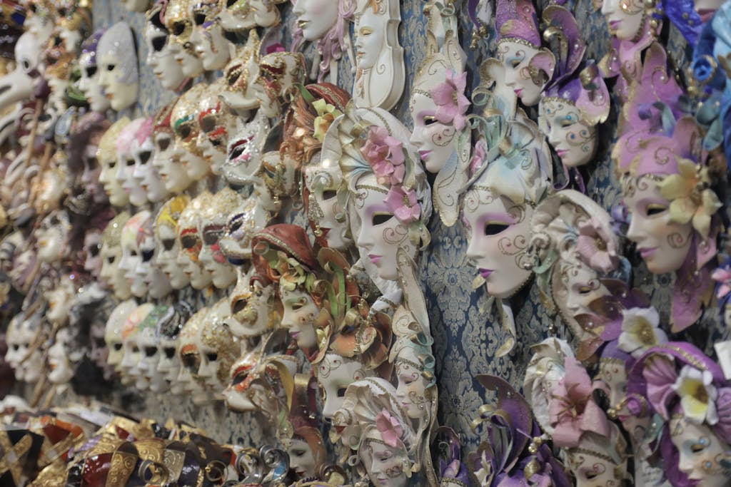 A vibrant collection of Venetian masks on display, showcasing ornate and traditional designs.