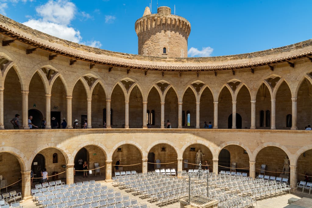 Panoramic view of Bellver Castle's courtyard in Palma, featuring Gothic architecture and historic ambiance.