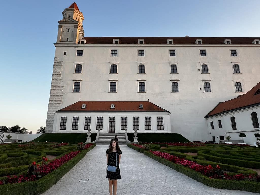 Chloe standing in the gardens to the side of Bratislava castle.