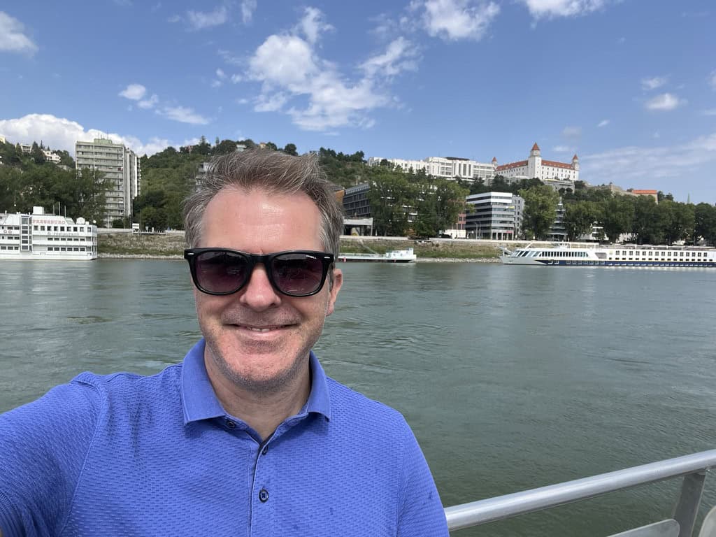 Adam arriving in Bratislava on the river ferry, with Bratislava castle in the background.