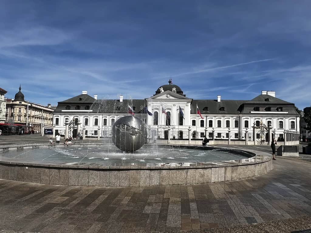 The planet of peace fountain in Bratislava with the presidential palace behind.