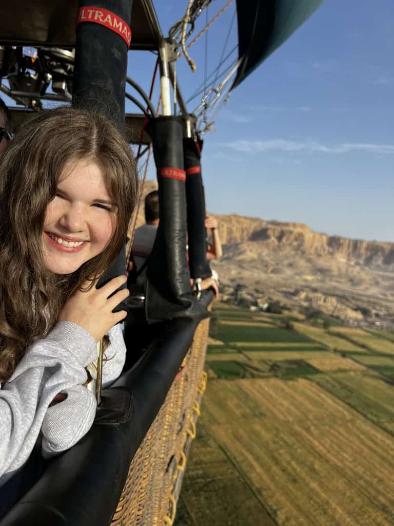 Teenager on a hot air balloon flying over the Luxor west bank.