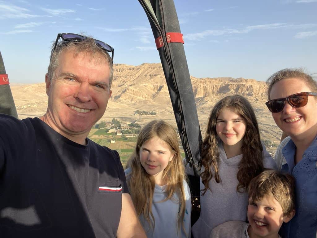 Family in a hot air ballon in Luxor flying over the desert on the West Bank.
