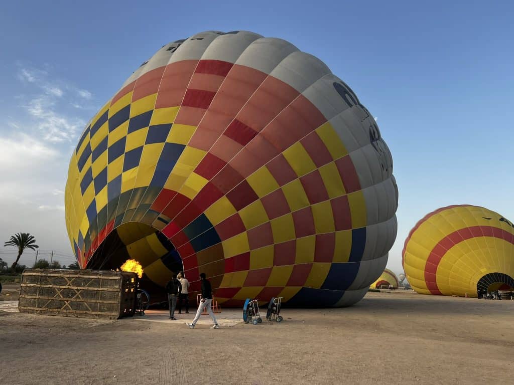 Hot air ballon being filled with air on the air field on the west bank of Luxor. 