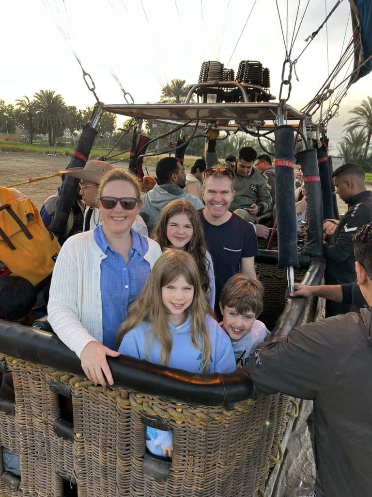 The mini travel tribe family in the hot air balloon ready to take off in Luxor. 