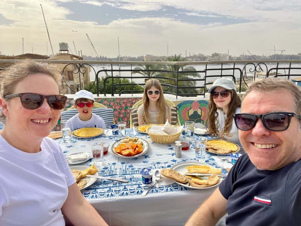 A family selfie sat round a table on the rooftop of Villa Belzoni in Luxor eating breakfast.