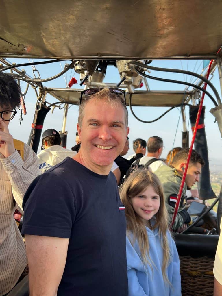 Adam and Martha in the hot air balloon, below the metal plate protecting from the worst of the hot air balloon flame's heat.