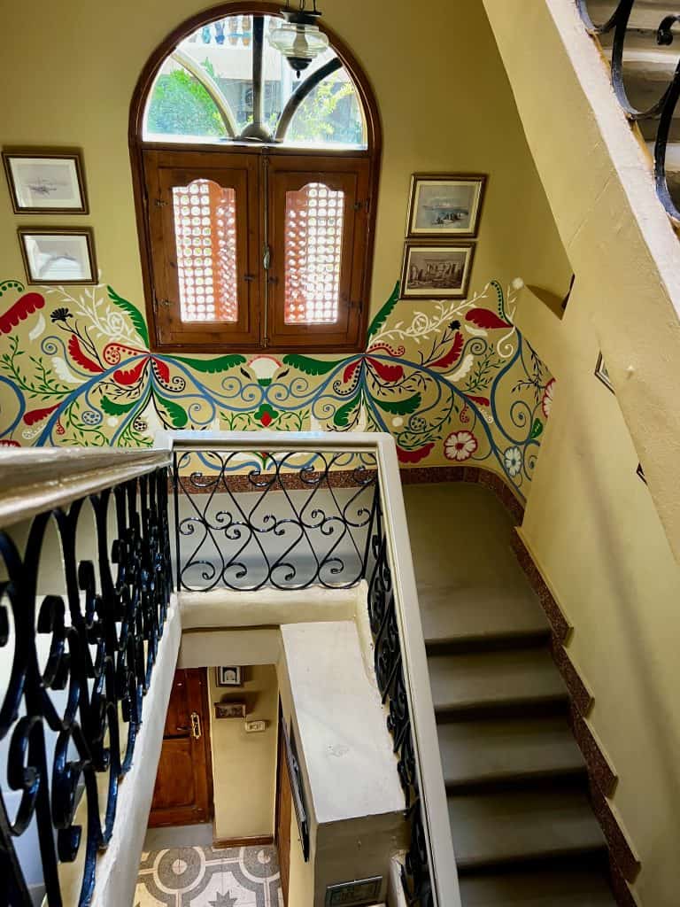 The staircase at Villa Belzoni, with beautifully painted patterns covering the walls. 