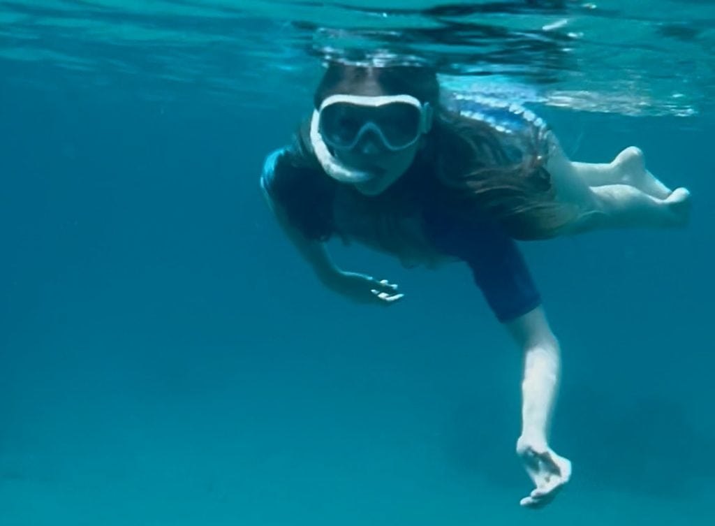 Child snorkelling in the Red Sea in Makadi Bay, Egypt.