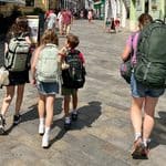 Family walking through Bratislava carrying backpacks.