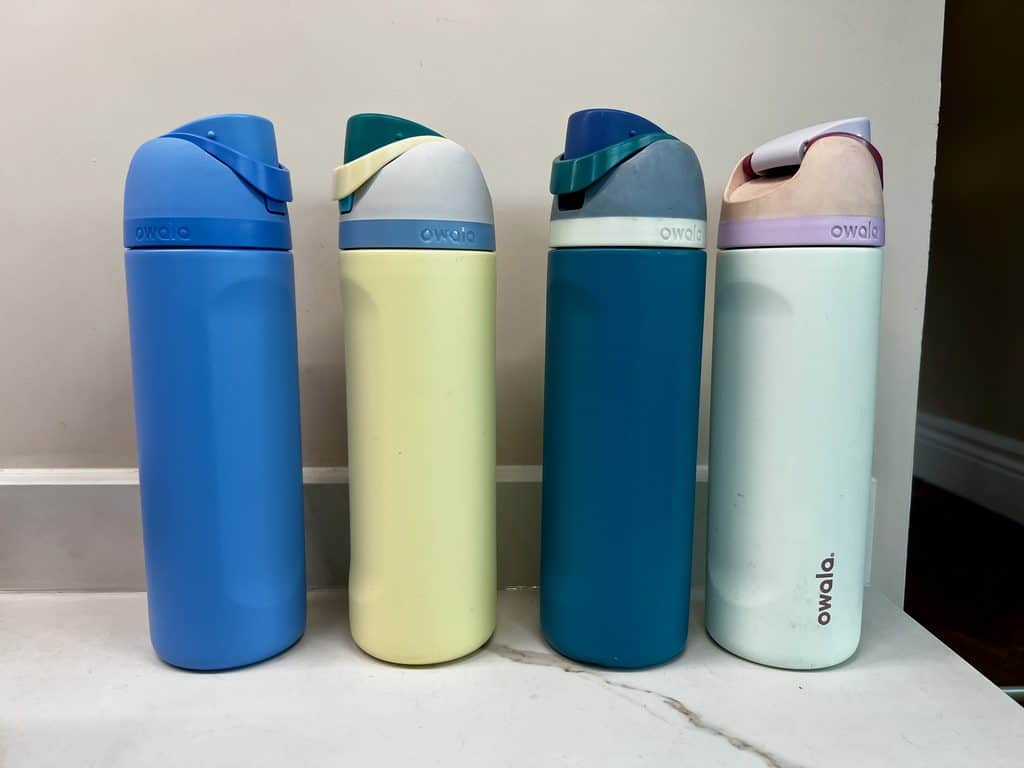 Our families collection of four Owala water bottles in different colours.